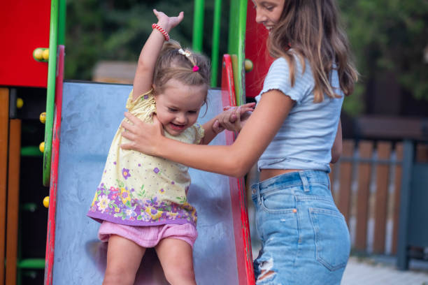 istock a little girl is going down a slide 2190296554