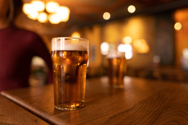 istock Refreshing beer served on wooden table in cozy pub 2190296956