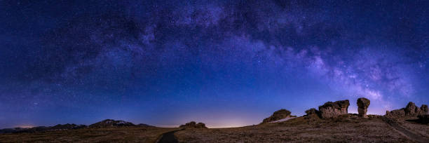 istock Moonlit Mushrom Rocks Mily Way Panorama 2190296998