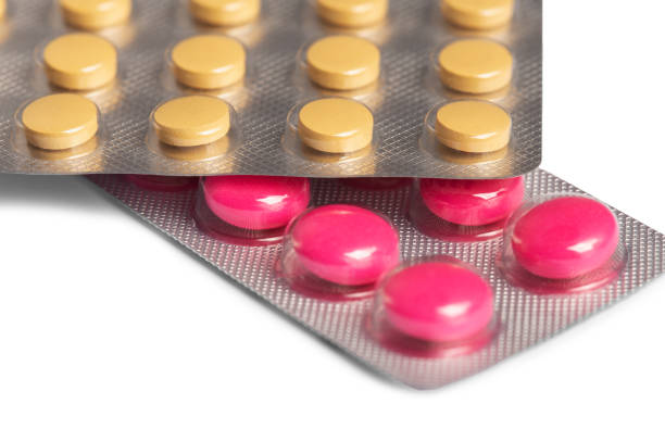 istock colored medical pills pink and yellow on white background 2190297773