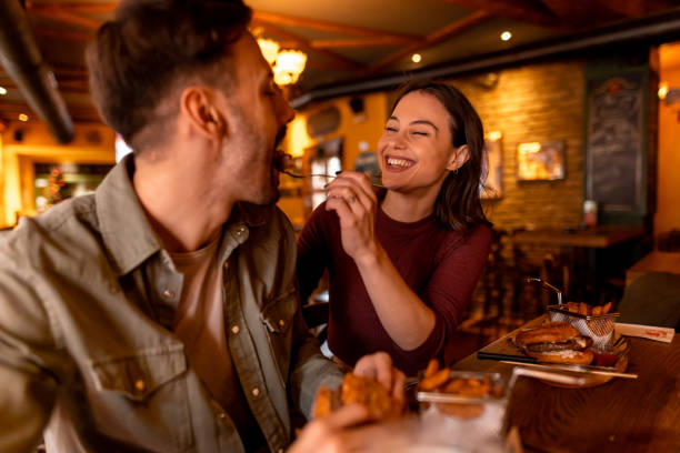 istock Couple sharing food and enjoying a date at restaurant 2190297792