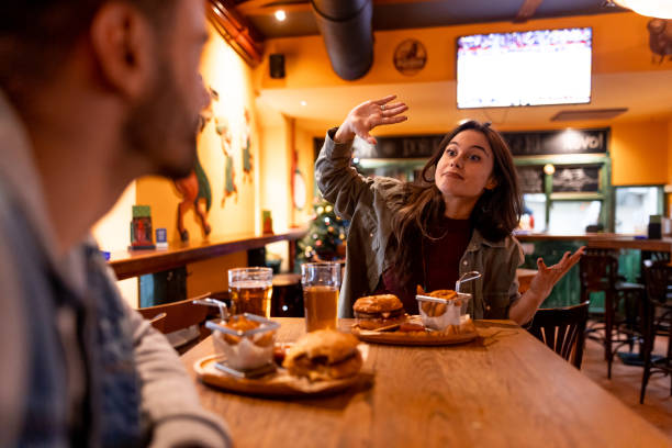 istock Young woman complaining about something while having dinner with a friend in a restaurant 2190297969