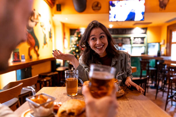 istock Friends toasting with beer glasses in cozy pub during christmas time 2190298053