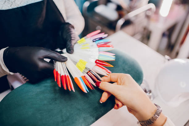 istock Woman choosing a nail color 2190300799