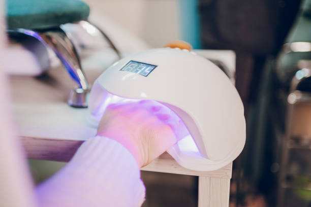 istock A hand inside a UV lamp for drying nail polish 2190300859