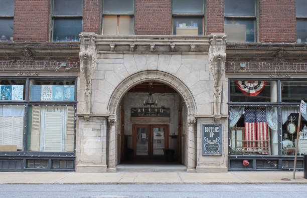 The arched entrance to a historic factory building with bunting in the window in Kansas City, Missouri