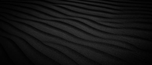 istock Black Sand dune. Black Sand beach macro photography. Background, texture, wave pattern of oceanic sand on the beach, black. Texture of beach sand. Black beach. 2190302114