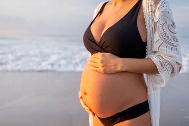 istock Pregnant woman enjoying the beach 2190303143
