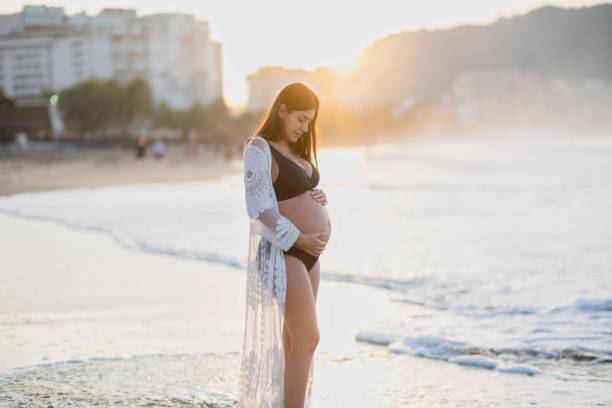 istock Pregnant woman enjoying the beach 2190303145
