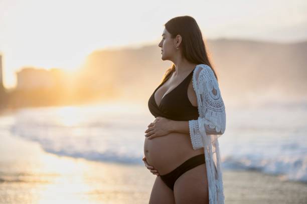istock Pregnant woman enjoying the beach 2190303183
