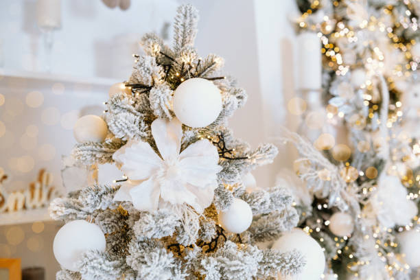 istock Decorative Christmas tree adorned with white ornaments and gleaming lights 2190305351