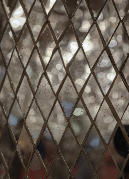 The pattern of Square mirrored tiles with shiny lighting reflected in them. Texture mirror tiles background, use it as your Wallpaper, Poster and Space for text, Selective focus.