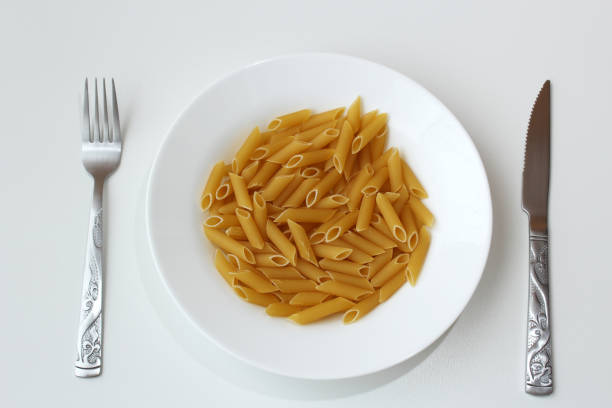 Raw italian gluten food on white dish. Dinning, hunger, meal, diet concept.