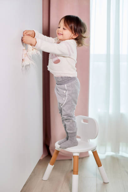 istock child girl decorates her room before Christmas 2190306014
