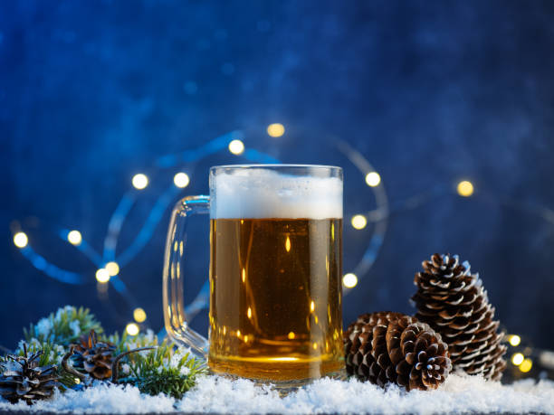 istock Beer mug on Christmas snow-covered table , blue background with garland and copy space 2190314724