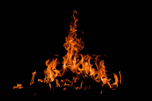 Fire over black background. Fire sparks background. Abstract dark background. Texture of fire on black background