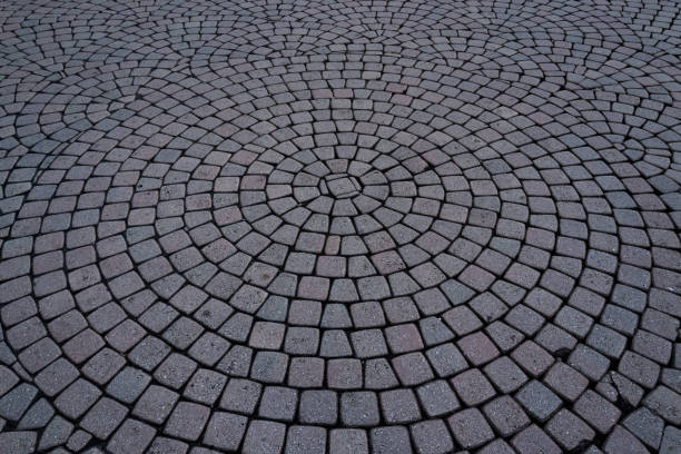 istock Stone road texture. Stone walk background. Granite cobblestoned pavement background. Rough brick road. Side walk. Stone cladding pavement. 2190316530