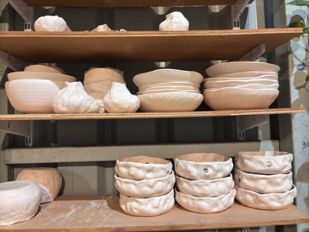 istock A shelf full of white ceramic bowls and vases 2190317282