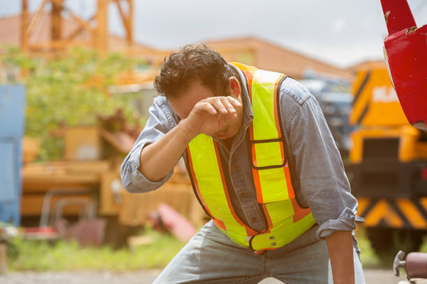 istock Senior Asian male construction builder tired and thirst of water at construction site. Construction workers have health problems and sick. Health safe of work and safety first concept 2190322342