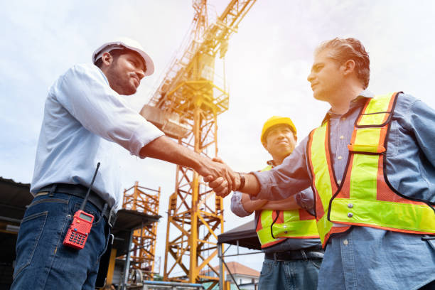 istock Group of male engineer construction putting their hands together at construction site. Teamwork of male construction builder at construction site. Unity and teamwork concept 2190322354