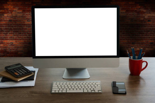 man working Businessman using a desktop computer of the blank screen at the wooden working desk.