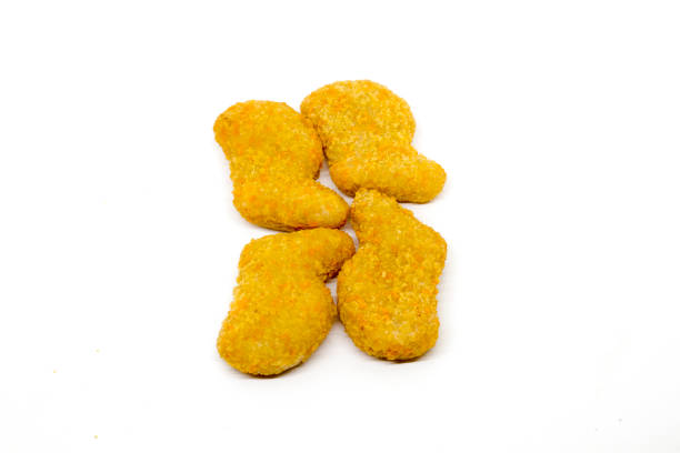 istock Golden crispy chicken nuggets isolated on a clean white background. 2190328321