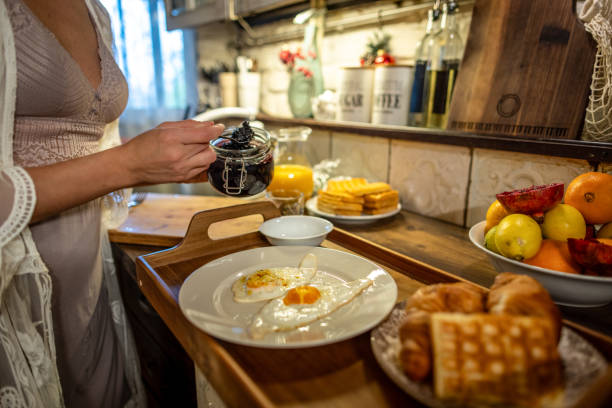 Photo of young woman preparing breakfast at home