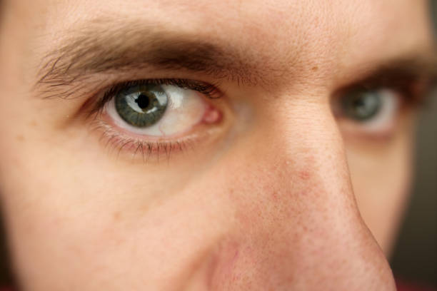 istock Intense gaze with gray eyes. Man looks curiously into camera 2190337147