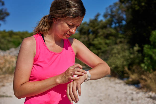 istock Female athlete using fitness watch while running on sunny day 2190337574
