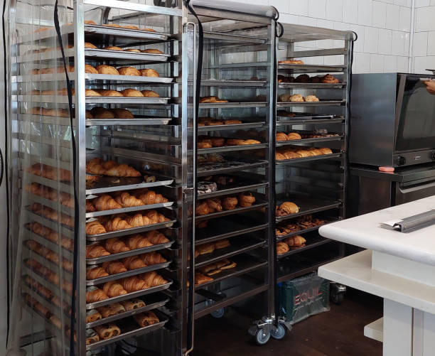 istock Croissant trolley - Baked croissants placed on a trolley tray. 2190338064