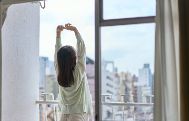 istock A young woman stretching on the balcony. 2190339968