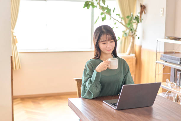 istock Young Japanese woman using a laptop 2190340150