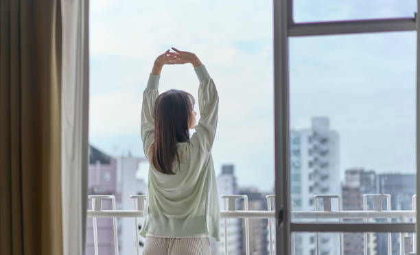 istock A young woman stretching on the balcony. 2190340398