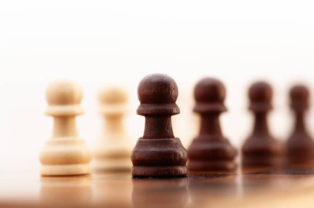 istock A black and white chess piece is on a board with other pieces 2190340826