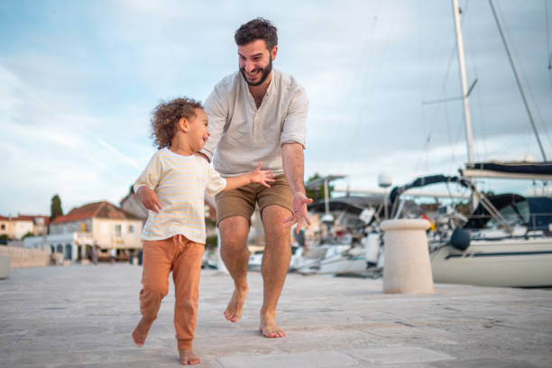 istock Playful Father and Diverse Boy Enjoying Pier Adventure 2190342056