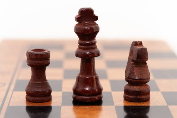 istock A black and white chess piece is on a board with a black and brown piece 2190342066