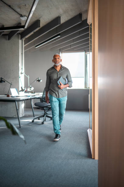 istock Confident Hispanic Businessman Engages with Digital Tablet in Office 2190342220