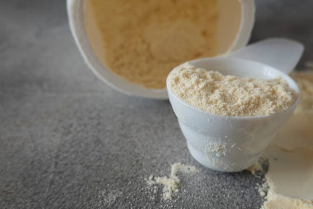 istock Open container with colostrum powder and measuring scoop 2190343193