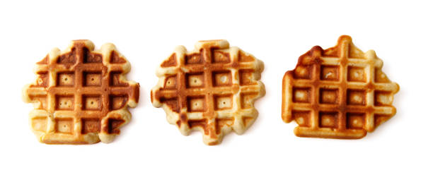 Three waffles are shown, one of which is burnt. The other two are golden brown. The burnt waffle is in the middle of the other two
