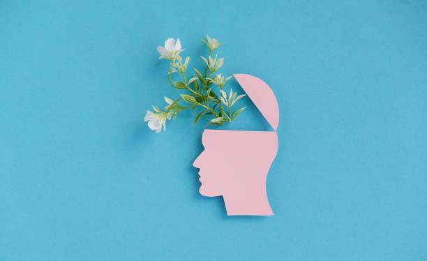 istock A head with a flower in it is on a blue background 2190345157