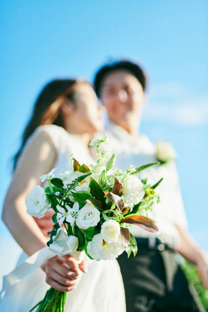 istock A wedding couple holding a bouquet 2190345725