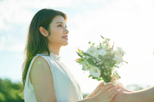istock Couple handing over wedding bouquet 2190345783
