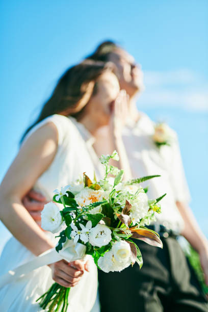 istock A wedding couple holding a bouquet 2190346312
