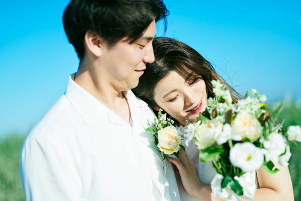 istock A couple taking wedding photos in a flower garden 2190346449