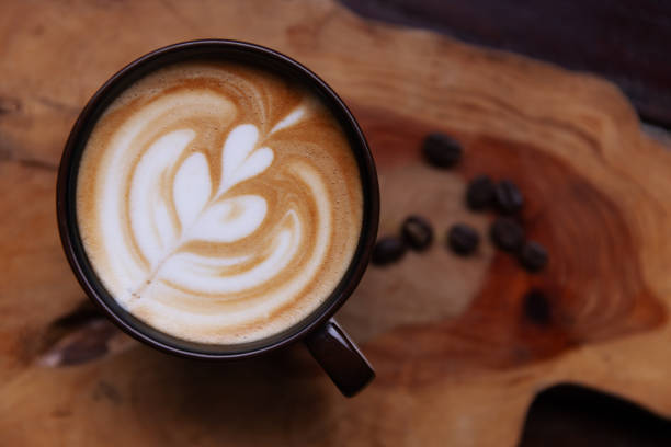 istock Cup of Coffee with Intricate Latte Art on Wooden Table, 2190347021