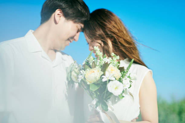 istock A couple taking wedding photos in a flower garden 2190347302