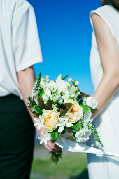 istock A wedding couple holding a bouquet 2190348754