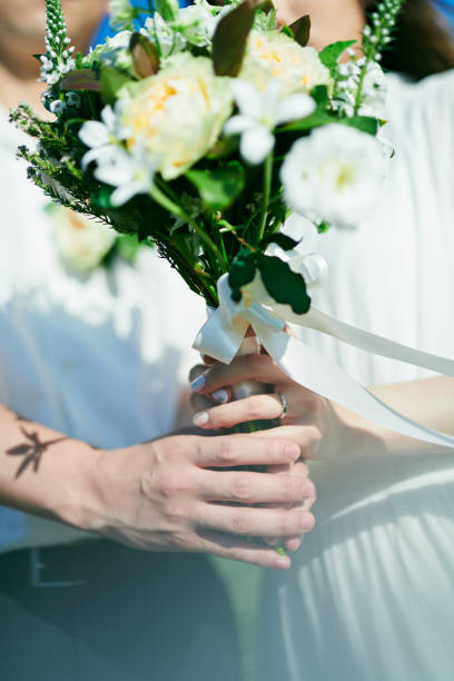 istock A wedding couple holding a bouquet 2190348776