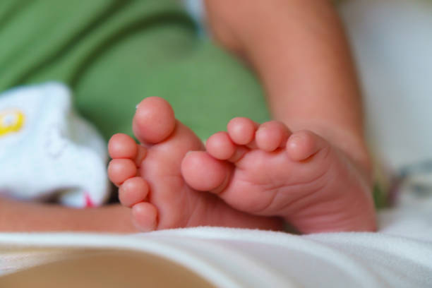 istock Tiny baby feet resting on soft surface, showcasing delicate toes and smooth skin. warmth and innocence of infancy are beautifully captured in this close up image 2190348832