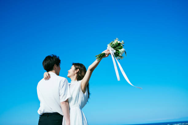 istock A wedding couple holding a bouquet 2190348877